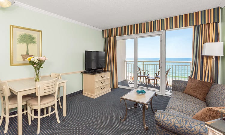 Features two queen beds, one full sleeper sofa, and one bathroom. Amenities include a fully-equipped kitchen and private oceanfront balcony.