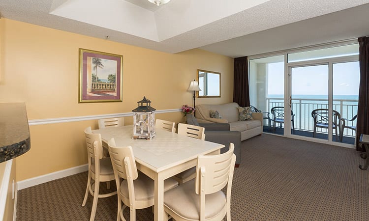 Features one king bed, two queen beds, one full sleeper sofa, and two bathrooms. Amenities include a fully-equipped kitchen, dishwasher, washer and dryer, and a private, oceanfront balcony.